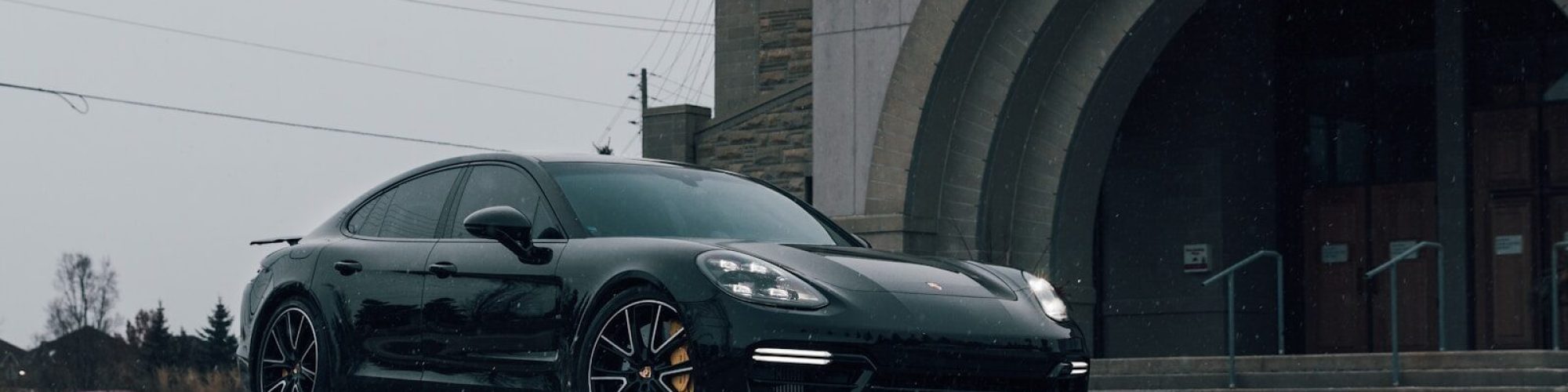 black coupe parked near building